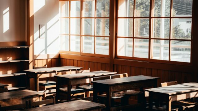 Empty Classroom with Wooden Desks and Windows